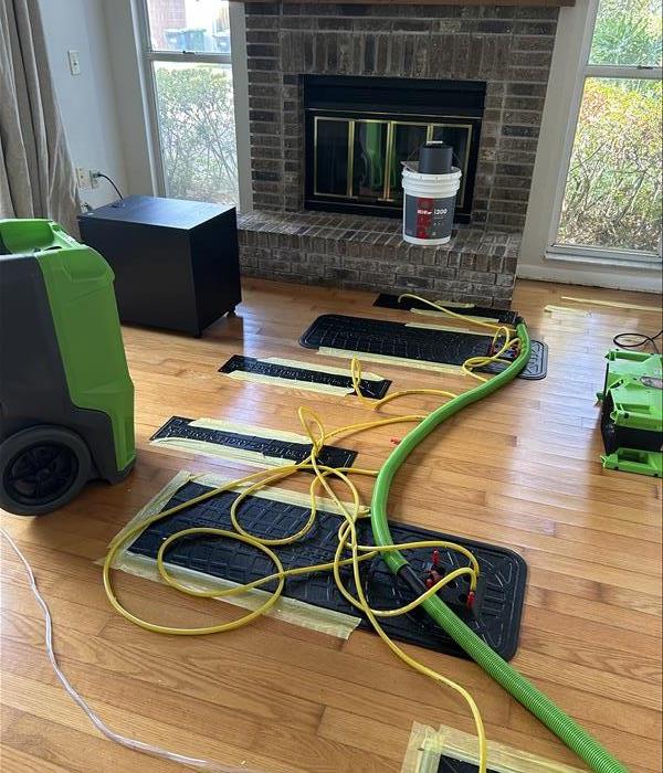 Drying equipment on a floor in a living room.